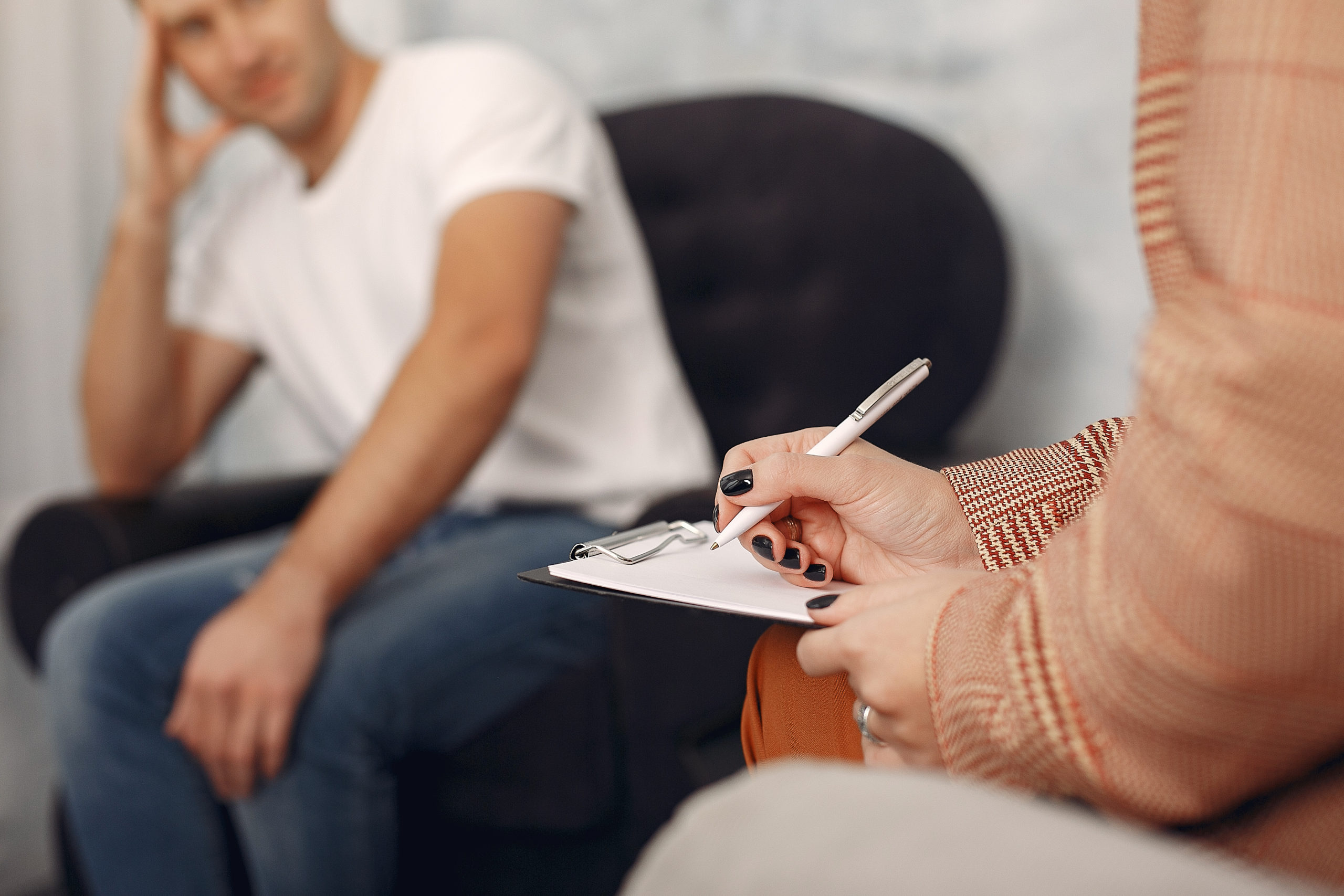 Man sitting in the psychologist's office and talking about probl